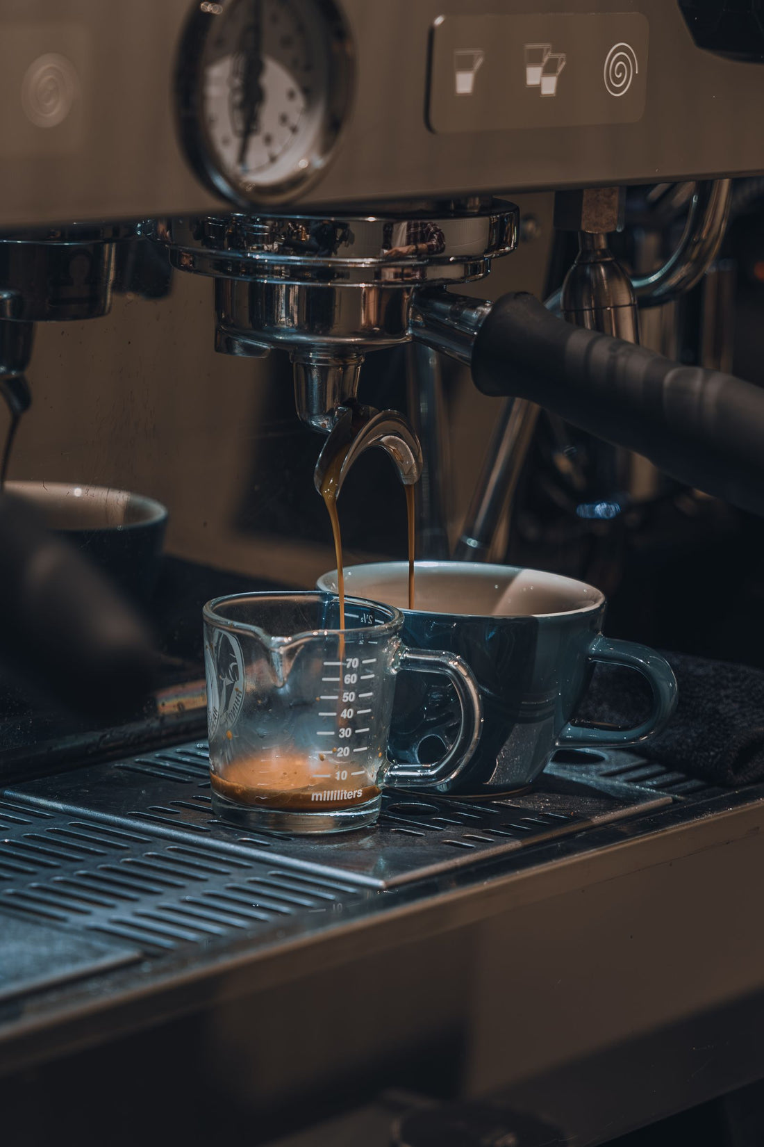 Close-up of an espresso machine brewing a shot